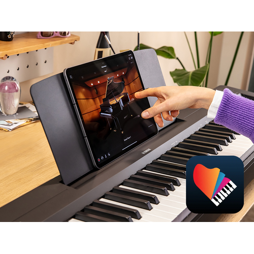 The Yamaha “Smart Pianist” app icon, together with a tablet placed on the music stand of the P-145BT