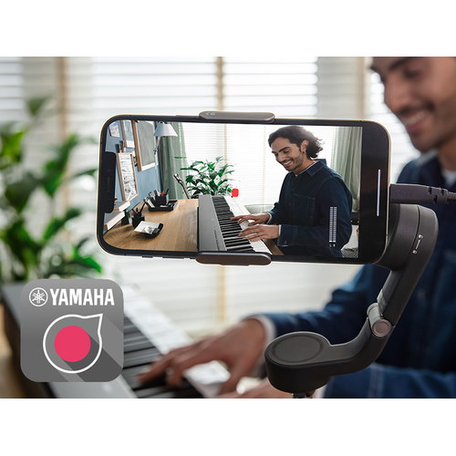 A view of the Yamaha Rec'n'Share app icon and a person taking a smartphone video of them playing